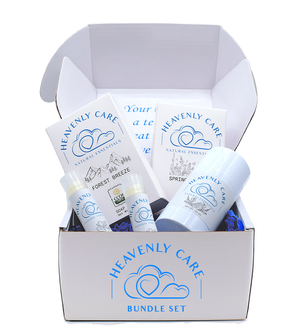 Open box of Heavenly Care natural skincare essentials bundle with organic soap bars, deodorant, and lip balms.